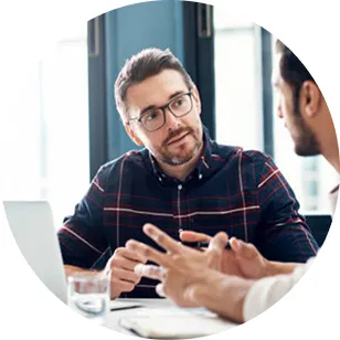 Two men talking across a table